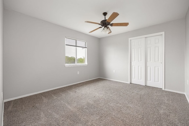 unfurnished bedroom with a closet, baseboards, carpet, and a ceiling fan