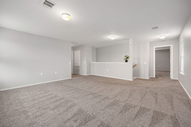 interior space featuring visible vents, baseboards, and carpet