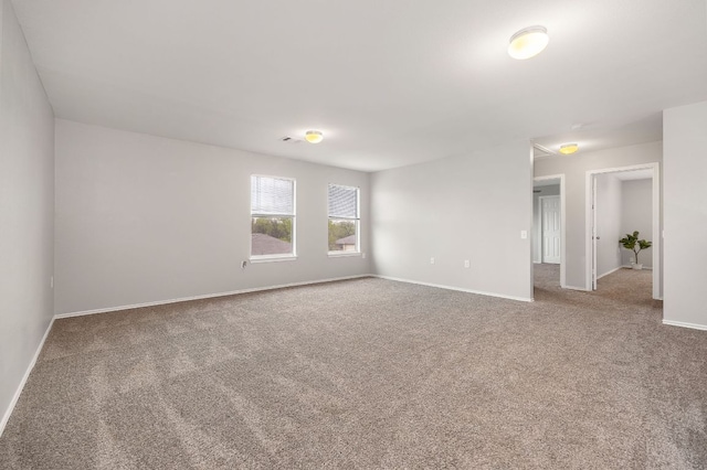 empty room with carpet and baseboards