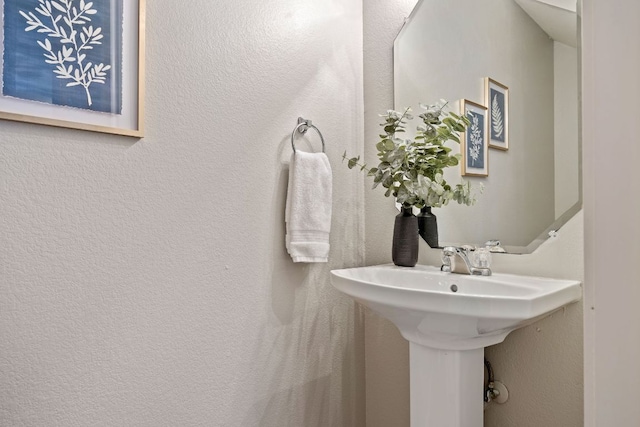 bathroom featuring a textured wall