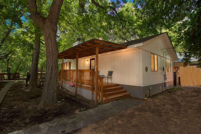 view of side of property featuring covered porch