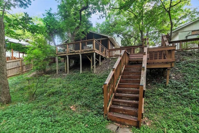 view of yard with stairway, a deck, and fence