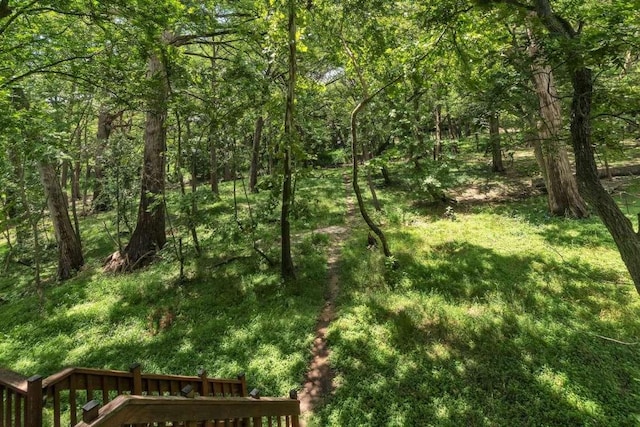 view of landscape featuring a forest view