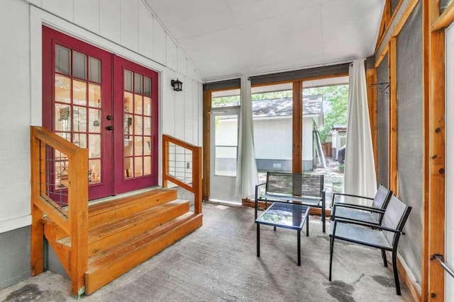 sunroom / solarium featuring lofted ceiling and french doors