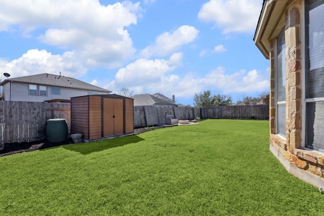 view of yard with an outdoor structure, a storage shed, and a fenced backyard