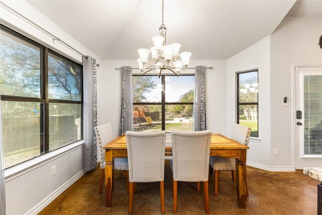 dining space featuring baseboards, lofted ceiling, plenty of natural light, and a chandelier