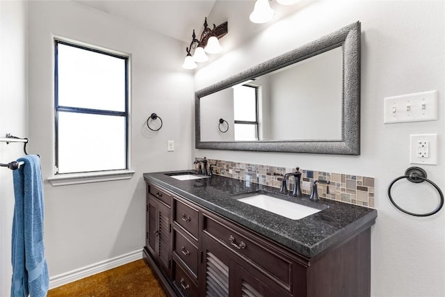 bathroom with decorative backsplash, plenty of natural light, and a sink