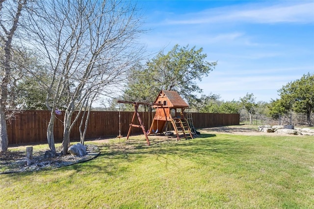 view of yard with a playground and a fenced backyard