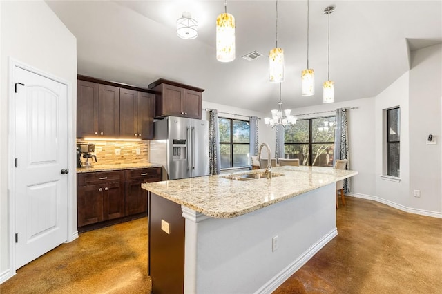 kitchen with visible vents, stainless steel refrigerator with ice dispenser, a sink, backsplash, and concrete flooring