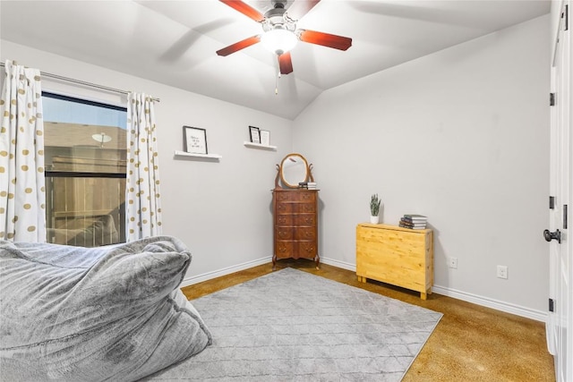 bedroom with lofted ceiling, a ceiling fan, and baseboards