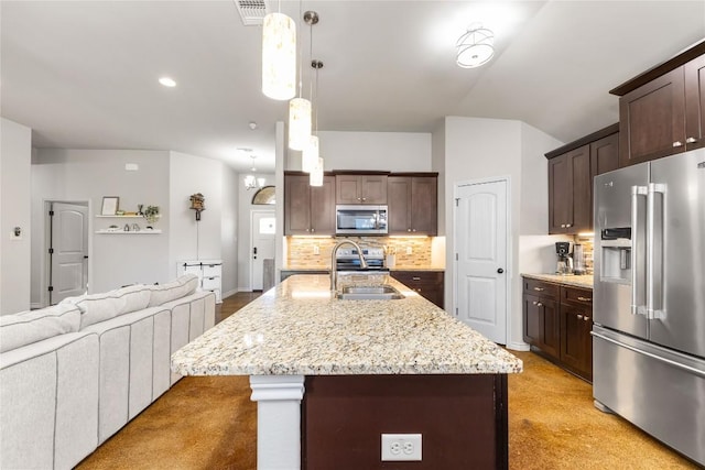 kitchen featuring visible vents, a sink, backsplash, appliances with stainless steel finishes, and dark brown cabinets