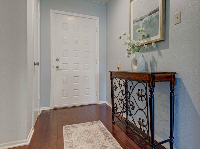 entrance foyer with baseboards and dark wood-style floors