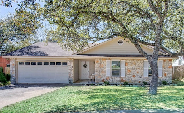 single story home with a front lawn, stone siding, fence, concrete driveway, and a garage