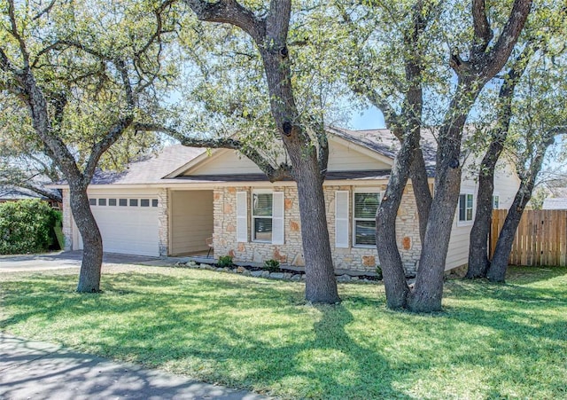 ranch-style home with a front lawn, an attached garage, fence, and stone siding