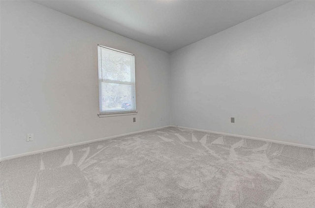 unfurnished room featuring baseboards and carpet flooring