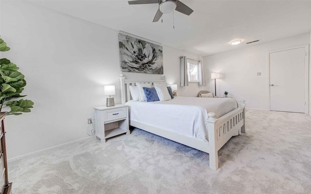 bedroom featuring visible vents, light carpet, baseboards, and a ceiling fan