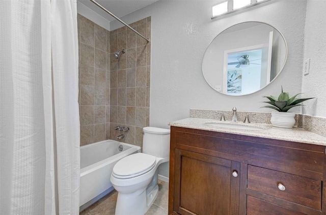 full bath featuring tile patterned floors, shower / bath combo with shower curtain, toilet, vanity, and a textured wall