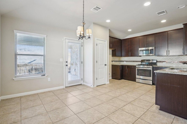 kitchen featuring visible vents, dark brown cabinets, appliances with stainless steel finishes, and decorative backsplash