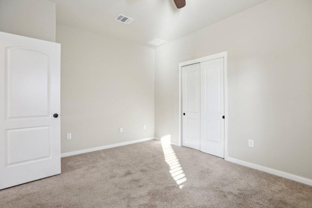 unfurnished bedroom featuring visible vents, baseboards, a closet, and carpet flooring