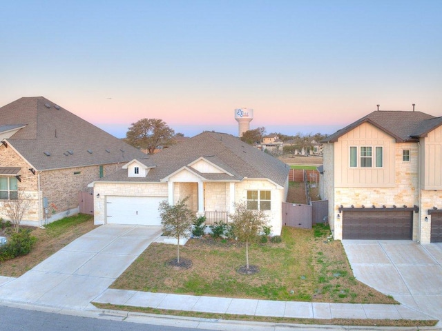 view of front of home with fence, a yard, board and batten siding, concrete driveway, and a garage