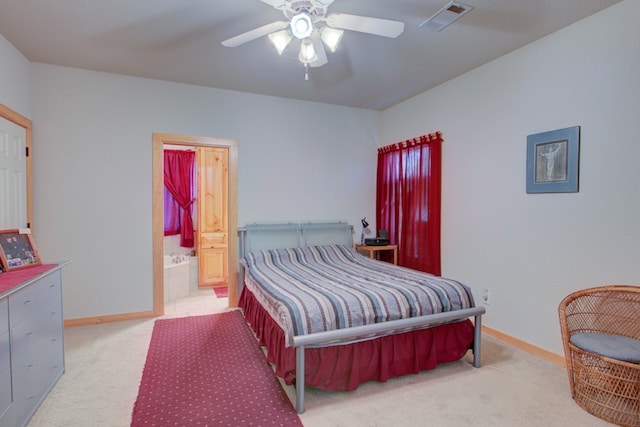 bedroom featuring ensuite bath, baseboards, visible vents, and carpet floors