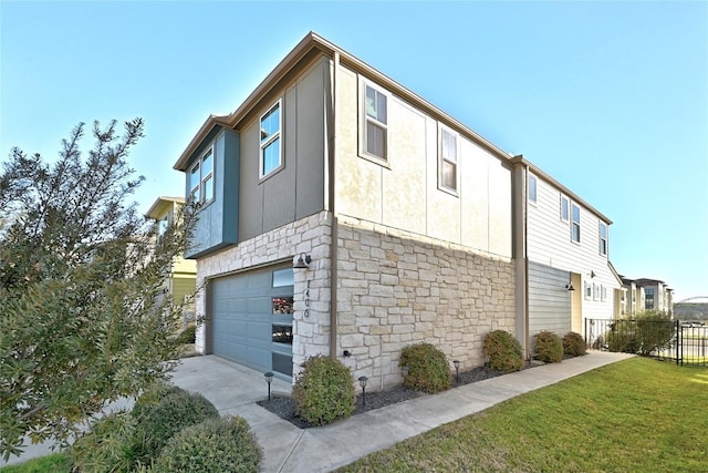 view of property exterior with fence, a lawn, stucco siding, stone siding, and an attached garage