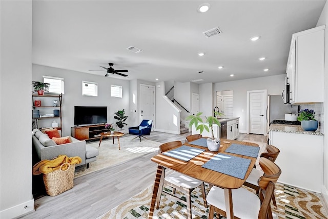 dining area featuring light wood finished floors, visible vents, and recessed lighting