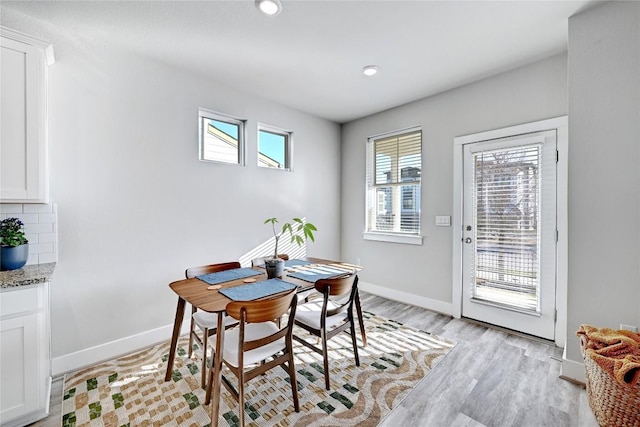 dining space with recessed lighting, baseboards, and light wood finished floors