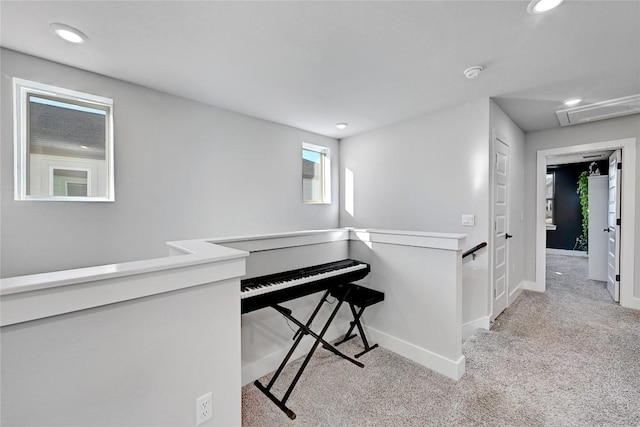 hall with recessed lighting, an upstairs landing, light colored carpet, and baseboards