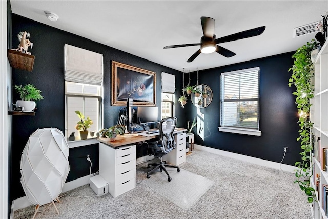 home office with light colored carpet, baseboards, visible vents, and ceiling fan