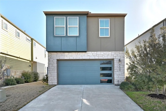 contemporary home with an attached garage, stone siding, driveway, and stucco siding