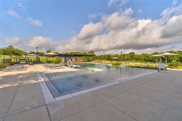 view of swimming pool featuring a patio