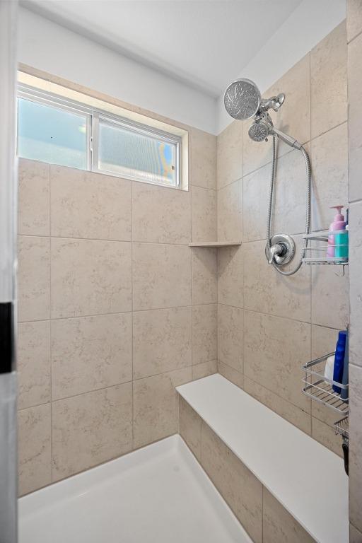 bathroom featuring tiled shower