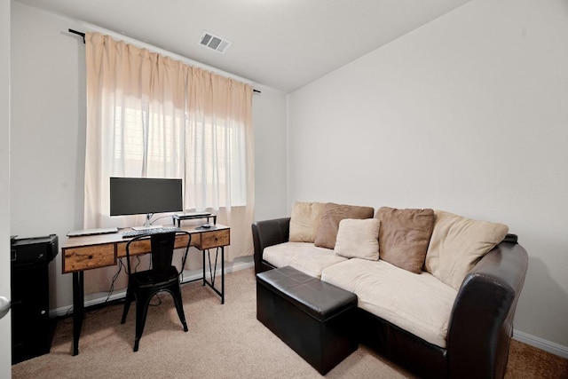 carpeted home office featuring vaulted ceiling, baseboards, and visible vents