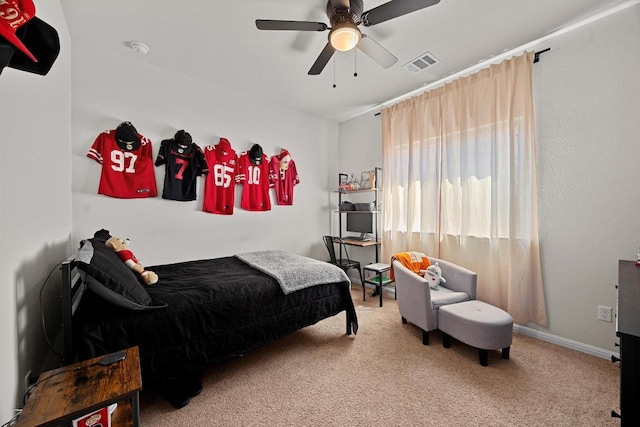 carpeted bedroom featuring visible vents and ceiling fan