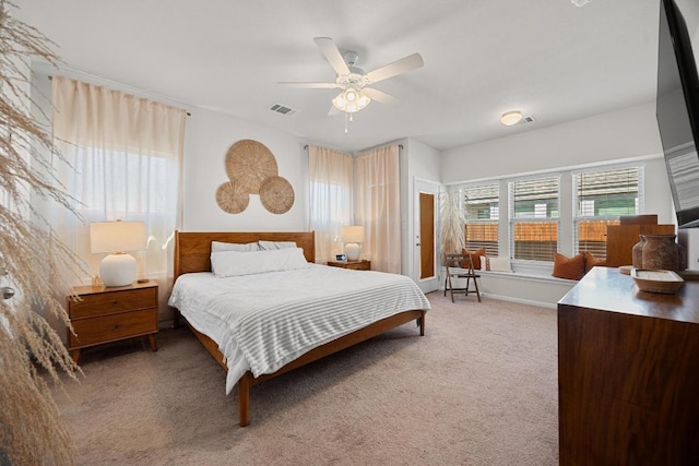 bedroom with a ceiling fan, light colored carpet, and visible vents