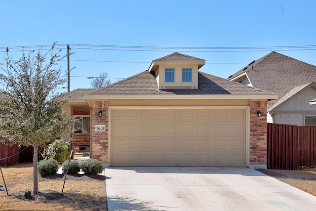 view of front facade with fence, driveway, a shingled roof, a garage, and brick siding