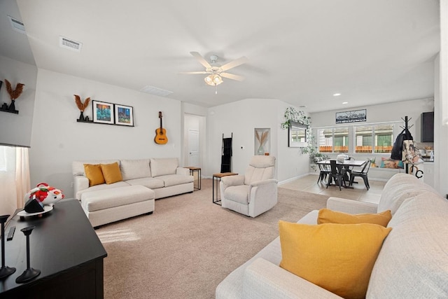 living area featuring visible vents, baseboards, ceiling fan, light carpet, and recessed lighting