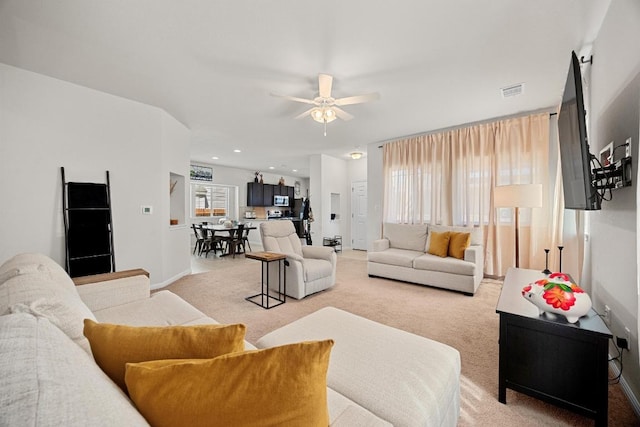 living area with baseboards, visible vents, recessed lighting, ceiling fan, and light carpet