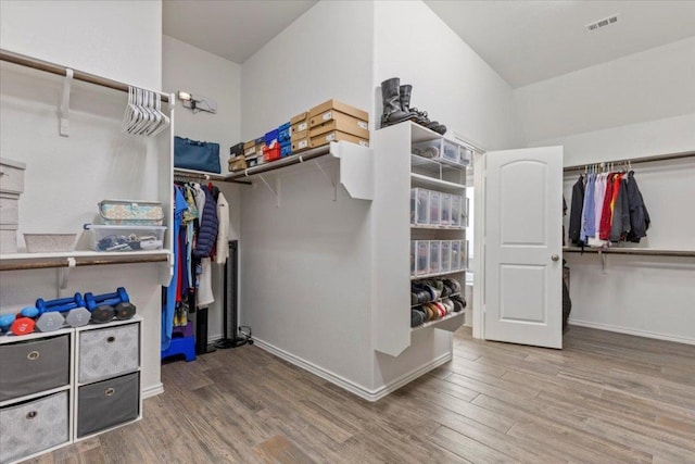 walk in closet with visible vents and wood finished floors