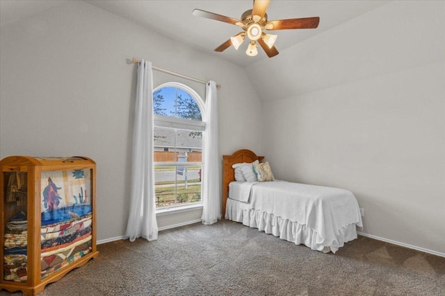 bedroom featuring vaulted ceiling, multiple windows, and carpet