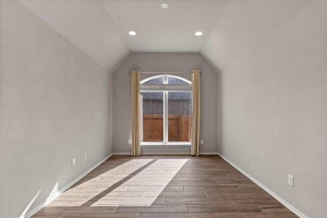 bonus room with dark wood-type flooring, recessed lighting, baseboards, and vaulted ceiling