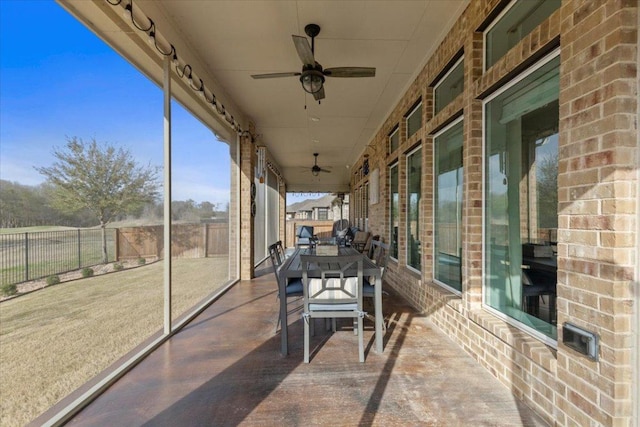 exterior space with ceiling fan and fence