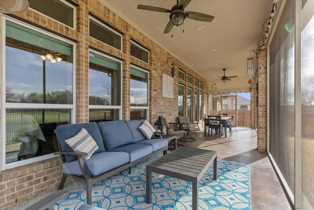 sunroom featuring ceiling fan