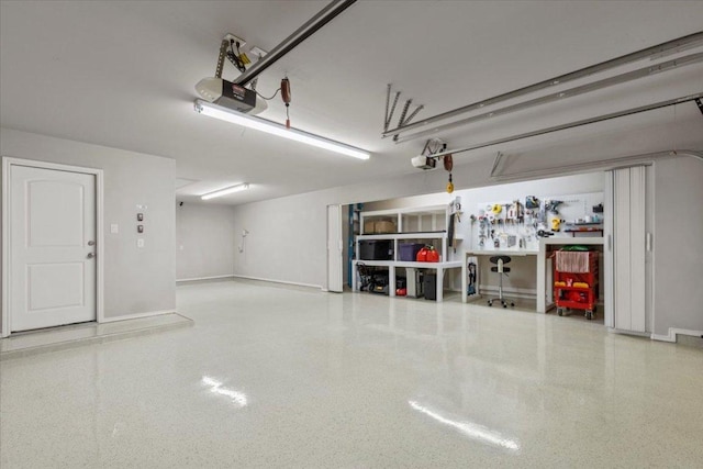 garage with a garage door opener and baseboards