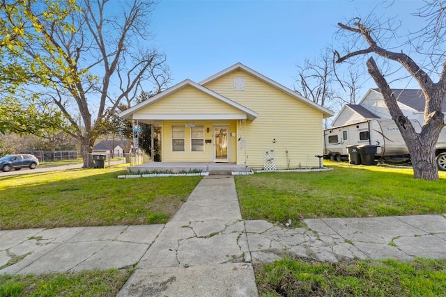 bungalow featuring a porch and a front lawn