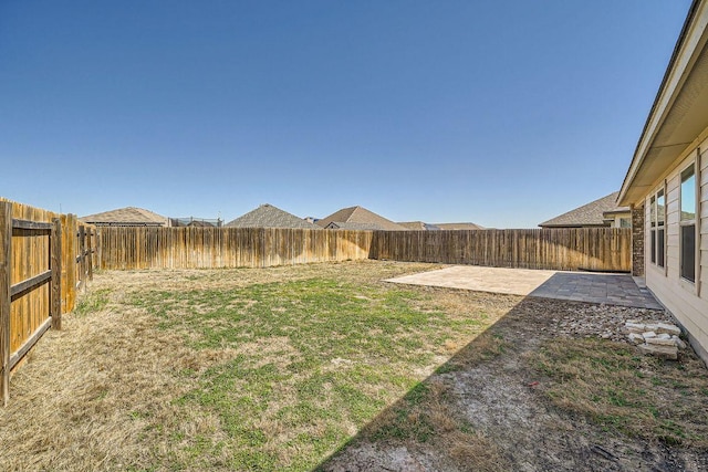 view of yard with a patio area and a fenced backyard