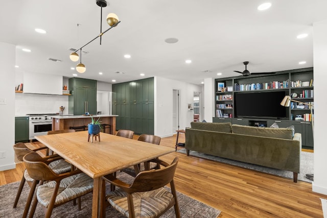 dining area with a ceiling fan, visible vents, light wood finished floors, baseboards, and recessed lighting