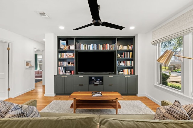 living area featuring baseboards, recessed lighting, visible vents, and light wood-type flooring