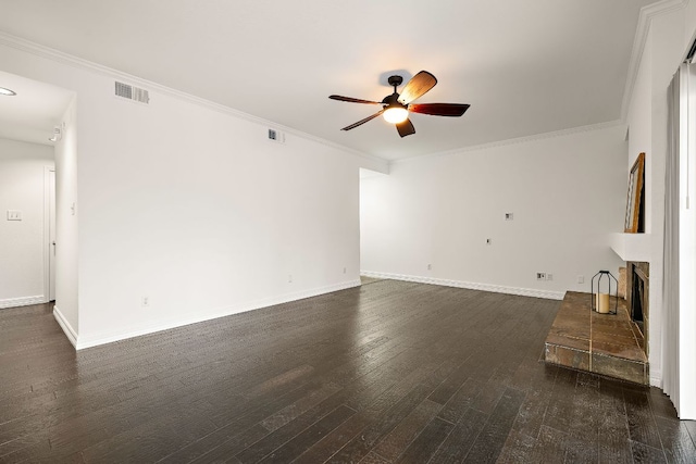 unfurnished living room with visible vents, a brick fireplace, crown molding, ceiling fan, and dark wood finished floors